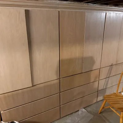 Sale Photo Thumbnail #215: Large light wood storage wardrobe unit featuring multiple upper cabinets and lower drawers, shown next to a wooden Windsor-style chair.