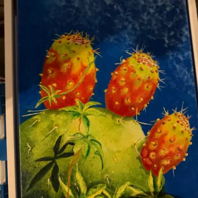 Sale Photo Thumbnail #202: Original oil painting on canvas depicting prickly pear cactus fruit against a deep blue sky, presented in a white floater frame.