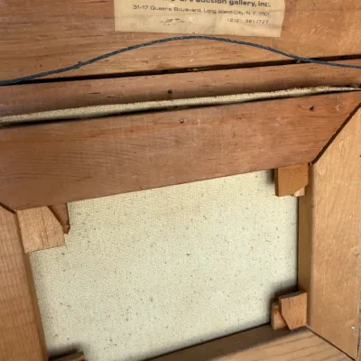 Sale Photo Thumbnail #129: Reverse side of a framed canvas painting, showing the wooden stretcher bars, corner keys, hanging wire, and a vintage gallery label from the National Art Auction Gallery, Inc.