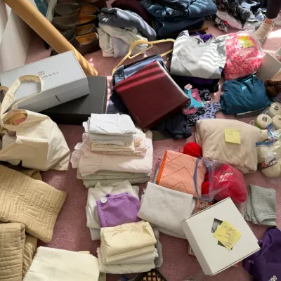 Sale Photo Thumbnail #109: Assorted household items, linens, clothing, and craft supplies arranged on a pink carpeted floor.