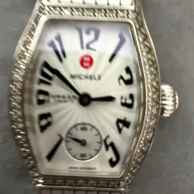 Michele Urban Mini diamond watch featuring a tonneau-shaped case, textured white dial with stylized numerals, and a stainless steel link...