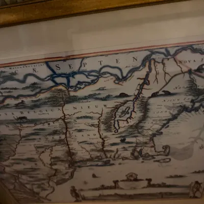Sale Photo Thumbnail #232: Framed reproduction of a historical map depicting "Nova Belgica et Anglia Nova," showing early colonial regions of North America.