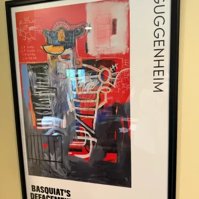 Framed exhibition poster for "Basquiat's Defacement: The Untold Story" at the Guggenheim Museum, running June 21 to...