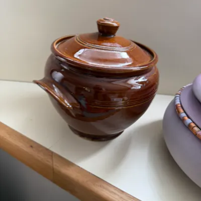 Vintage brown glazed ceramic bean pot with matching lid, featuring a glossy finish and side handles.