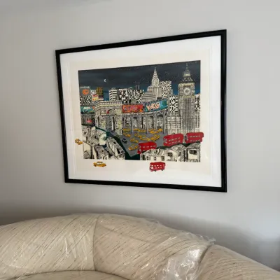 Charles Fazzino 3D pop art print featuring a whimsical global cityscape, professionally matted and framed in a black frame.