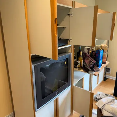 Modern laminate and light wood entertainment center with open cabinet doors, housing a Samsung CRT television.