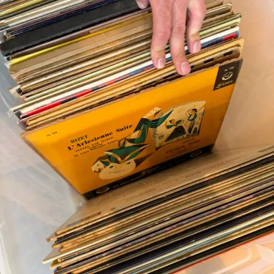 Collection of vintage vinyl records stored in a plastic bin, featuring Bizet's L'Arlesienne Suite on London Records.