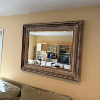 Large rectangular wall mirror featuring a wide, ornate wooden frame with a distressed, whitewashed finish.