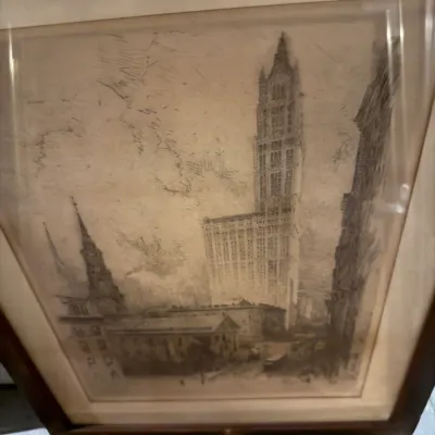 Sale Photo Thumbnail #224: Framed architectural etching depicting the Woolworth Building in New York City, presented in a dark wood frame with a mat.