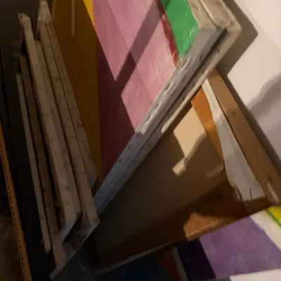 Sale Photo Thumbnail #205: Collection of stretched canvases, including some with colorful abstract paintings and several blank or unfinished frames.