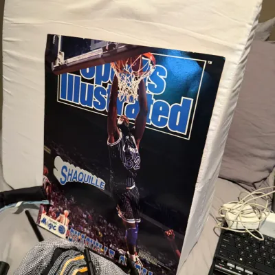 Sale Photo Thumbnail #155: Vintage Sports Illustrated poster featuring Shaquille O'Neal in his Orlando Magic uniform, showing some wear along the edges.