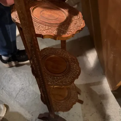 Sale Photo Thumbnail #244: Vintage Anglo-Indian carved wood three-tier folding cake stand, featuring intricate floral relief carvings on each tier.