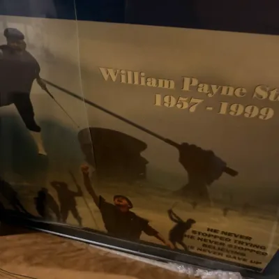 Sale Photo Thumbnail #233: Framed memorial poster for golfer William Payne Stewart (1957-1999), featuring silhouettes and images of his iconic swing and victory pose.