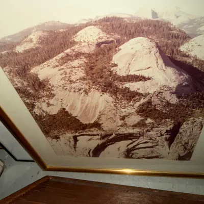 Sale Photo Thumbnail #225: Large framed sepia-toned landscape photograph depicting a mountainous region, possibly Yosemite, housed in a gold-finished frame with wide matting.