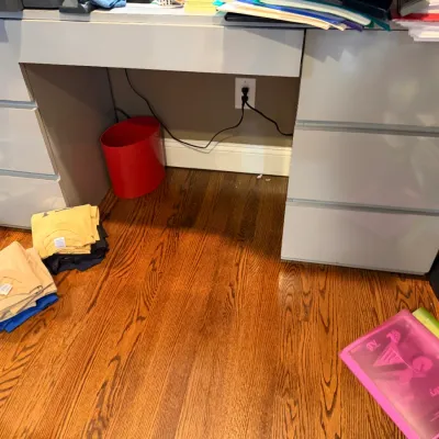 Sale Photo Thumbnail #166: Modern light gray double-pedestal desk featuring integrated drawer pulls and a spacious kneehole area, shown on hardwood flooring.