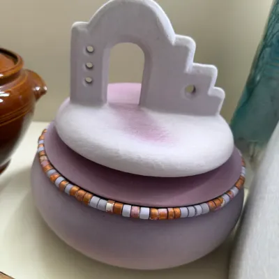 Southwestern-style lavender ceramic lidded vessel, featuring a beaded rim and an architectural arch-and-stairway handle, circa 1980s or...