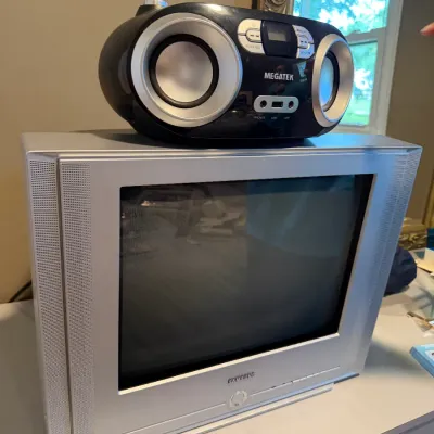 Sale Photo Thumbnail #156: Samsung silver CRT television with a Megatek portable CD player boombox resting on top.
