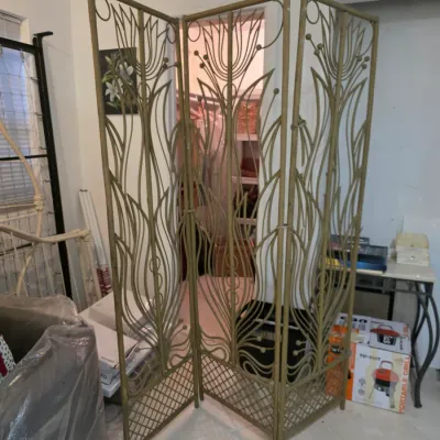 Vintage three-panel wrought iron room divider featuring an Art Nouveau-inspired floral and leaf design with a gold-toned finish.