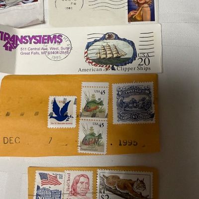 Sale Photo Thumbnail #100: A collection of vintage United States postage stamps on paper clippings, featuring various postmarks from the 1960s and 1990s. The lot includes notable stamps such as the 32¢ Marilyn Monroe, 29¢ Chief Joseph, 32¢ "Stonewall" Jackson, 20¢ American Clip