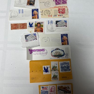 Sale Photo Thumbnail #98: A collection of vintage United States postage stamps on paper clippings, featuring various postmarks from the 1960s and 1990s. The lot includes notable stamps such as the 32¢ Marilyn Monroe, 29¢ Chief Joseph, 32¢ "Stonewall" Jackson, 20¢ American Clip