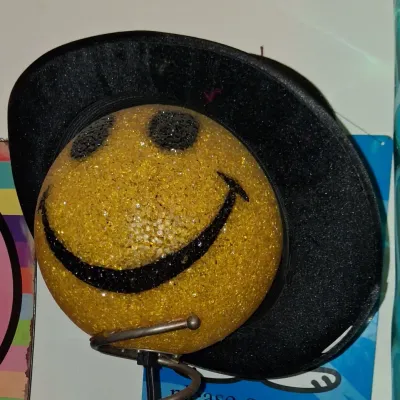 Sale Photo Thumbnail #21: Vintage melted plastic popcorn smiley face lamp wearing a black top hat, mounted on a metal spring base.