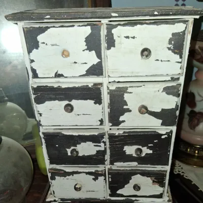 Sale Photo Thumbnail #49: Vintage miniature wooden chest of drawers with a heavily distressed, peeling black and white painted finish.