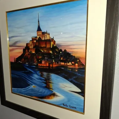 Sale Photo Thumbnail #142: Framed painting of Mont Saint-Michel by artist Emilia Condrea, featuring a gold inner border, wide cream matting, and a dark wood frame.