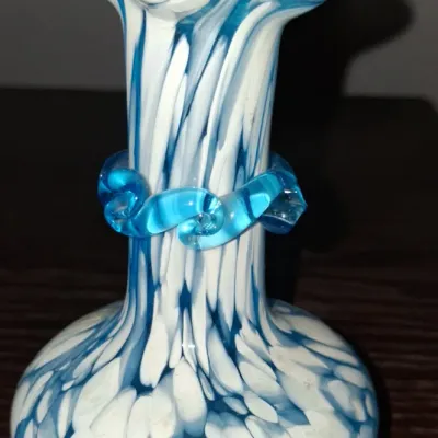 Sale Photo Thumbnail #122: Vintage hand-blown art glass vase featuring a blue and white spatter pattern, ruffled rim, and an applied blue glass collar around the neck.