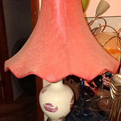 Sale Photo Thumbnail #27: Vintage ceramic table lamp featuring a white urn-shaped base with purple transferware landscape scenes, topped with a flared red fabric shade.