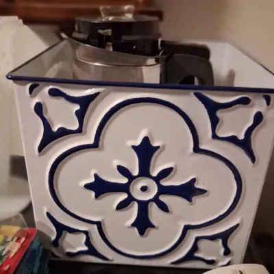 Sale Photo Thumbnail #73: Vintage-style white and blue enameled metal storage bin featuring an embossed tile pattern, holding a stainless steel coffee carafe.