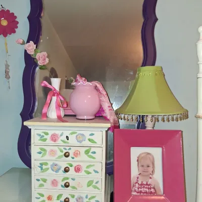 Sale Photo Thumbnail #40: Shabby chic bedroom decor including a hand-painted floral mini jewelry chest, a lime green lamp with beaded trim, a pink picture frame, and a purple-framed wall mirror.