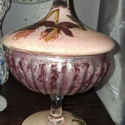 Sale Photo Thumbnail #115: Vintage hand-painted glass candy dish with a crackle-finish lid and base featuring floral motifs, paired with a fluted, metallic-finished purple bowl.