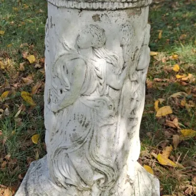 Sale Photo Thumbnail #2: Vintage concrete garden pedestal featuring a classical relief design of dancing figures, showing weathered patina and minor wear.