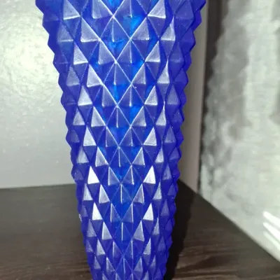 Sale Photo Thumbnail #116: Vintage cobalt blue pressed glass vase featuring a raised diamond point pattern and a flared rim, supported by a circular pedestal base.