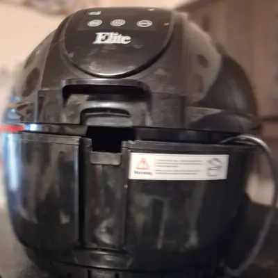Sale Photo Thumbnail #75: Elite brand black digital air fryer, showing some surface wear and dust from previous use.