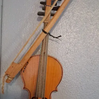 Sale Photo Thumbnail #95: Vintage miniature wooden violin and bow souvenir from Mexico, featuring handwritten "Mexico" on the upper bout.