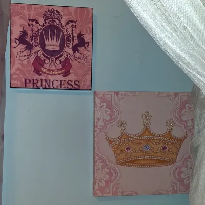 Sale Photo Thumbnail #36: Pair of pink princess-themed wall art canvases, featuring a crown illustration and a royal crest design.