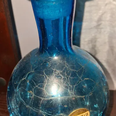 Sale Photo Thumbnail #126: Heritage hand-blown blue crackle glass vase with a flared rim and original gold foil label.