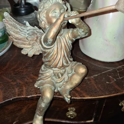 Sale Photo Thumbnail #48: Vintage cherub shelf sitter figurine with a gold finish and green patina, depicted playing a horn.