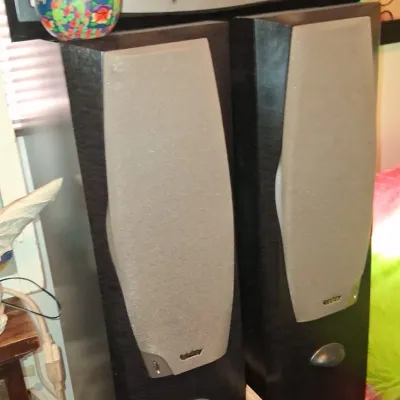Sale Photo Thumbnail #11: Pair of Infinity floor-standing tower speakers with grey grilles, shown with a matching horizontal center channel speaker.