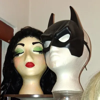 Sale Photo Thumbnail #19: Two styrofoam mannequin heads, one wearing a black wig with painted makeup and the other wearing a black Batman-style mask.