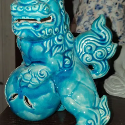Sale Photo Thumbnail #134: Vintage Chinese turquoise glazed ceramic Foo Dog figurine, depicted resting its paw on a pierced ball.
