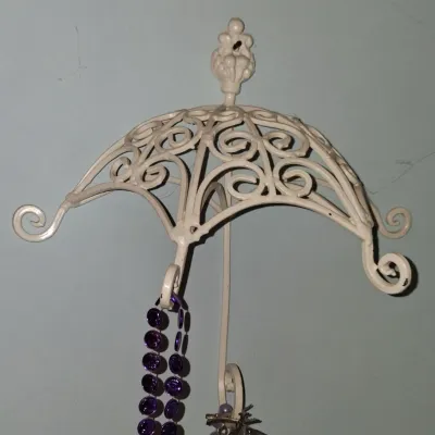 Sale Photo Thumbnail #51: Vintage white painted wrought iron umbrella-shaped wall hook, featuring scrollwork details and multiple hanging points.
