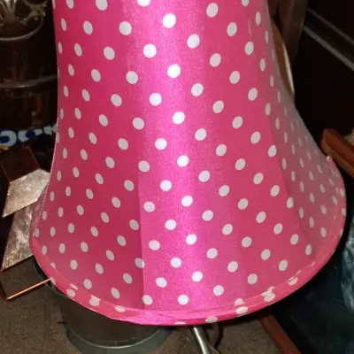 Sale Photo Thumbnail #46: Modern desk lamp featuring a brushed metal base and a vibrant pink lampshade with white polka dots.