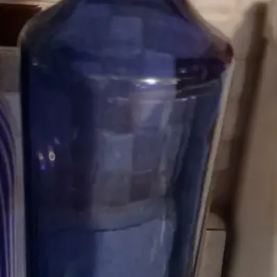 Sale Photo Thumbnail #79: Vintage cobalt blue glass decanter with a matching round stopper, featuring a tall, tapered body.