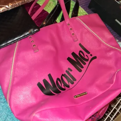 Sale Photo Thumbnail #38: Juicy Couture hot pink tote bag featuring "Wear Me!" graphic text on the front, accompanied by other assorted handbags.