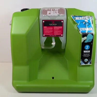 Sale Photo Thumbnail #117: Radians green plastic portable emergency eyewash station, showing some wear and peeling decals.