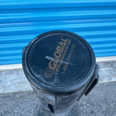 Sale Photo Thumbnail #48: Global Industrial retractable belt stanchion, showing top-down view of the post cap with branding.