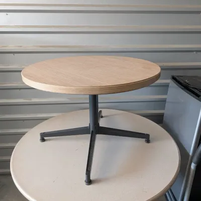 Sale Photo Thumbnail #33: Modern round side table featuring a light wood grain laminate top on a black metal pedestal base with four feet.