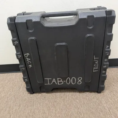 Sale Photo Thumbnail #290: Heavy-duty molded plastic equipment transit case in dark gray, marked with handwritten labels "BACK", "FRONT", and "TAB-008".